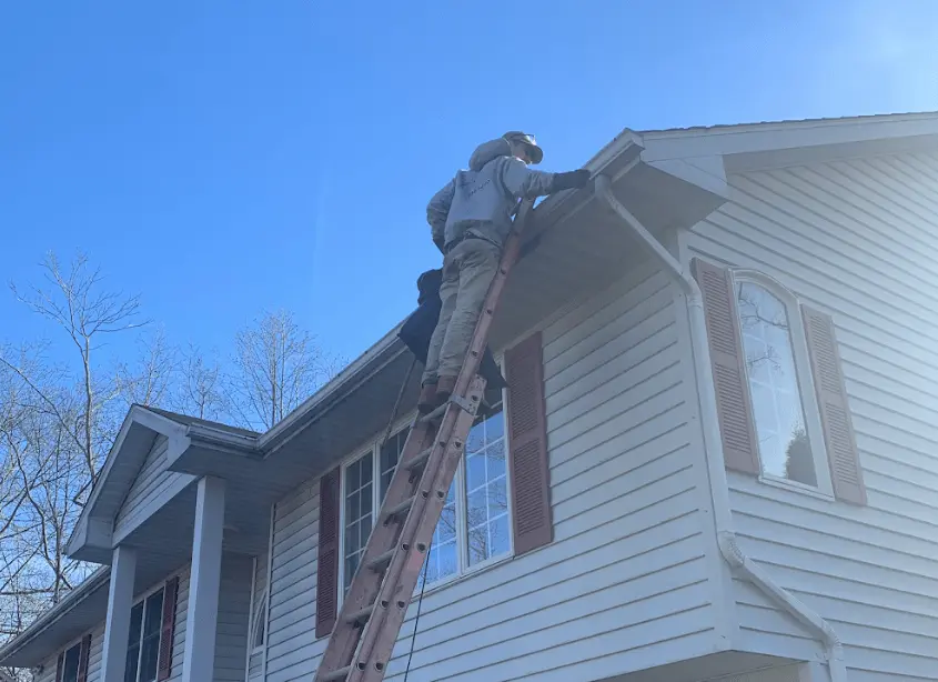 Gutter cleaning and maintenance being performed by Eastlake Power Washing in Eastlake